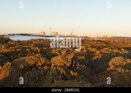 soil storage during construction, large piles of soil excavated from pits which is stored for use in vertical planning and landscaping Stock Photo