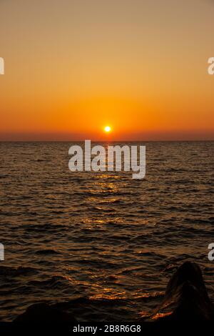 beautiful Sunny sunset on the sea. Amazing summer view on the beach.  Stock Photo