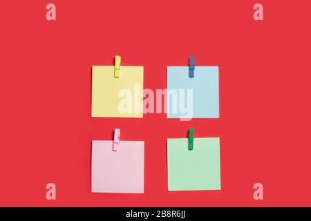 Reminder multicolored stickers on a red background Stock Photo