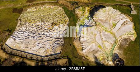 Elevated view photograph of geothermal activity produced thermal spring waters in Egerszalok, Hungary, that sit within colorful textured, terraced lim Stock Photo