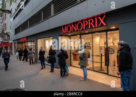 Paris, France. 21st Mar, 2020. People line up outside a supermarket in Paris, France, March 21, 2020. The number confirmed coronavirus cases in France has risen 1,559 within a day