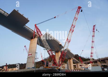 Genoa, Italy. 22th, Mar 2020.  A general view shows the construction of the new bridge in Genoa, (on the left) the bridge designed by the Italian architect Renzo Piano, which has been under construction since June 25, 2019 and which will open in the first half of 2020. Construction is stopped today due to the Corona Virus epidemic. The new decree issued by the Italian government on March 21, 2020 provides for new restrictions. Credit: ALEJANDRO SALA/Alamy Live News Stock Photo