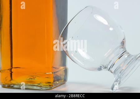 Whiskey bottle and cross-standing glass based on the bottle. , Stock Photo