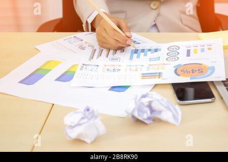 Close-up image of business executive analyzing diagram in financial report with sales data Stock Photo