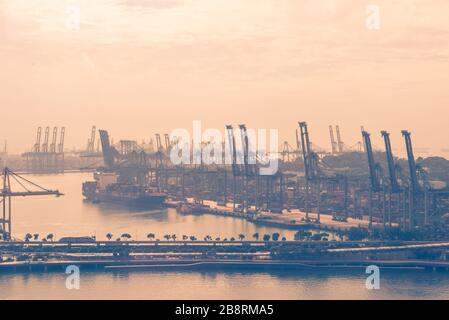 Container Cargo freight ship with working crane bridge in shipyard. Stock Photo