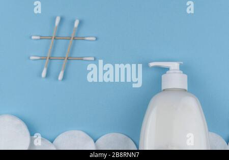 sanitizer gel and natural cotton sticks on blue background. stop the global epidemic of COVID-19. Coronavirus prevention Stock Photo