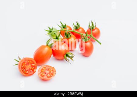 fresh red cherry tomatoes (grape tomatoes ) on white background. Stock Photo