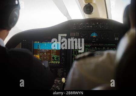 Jet dashboard abd two pilots in the blurred background Stock Photo