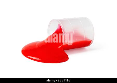 Red thick liquid is poured from a tilted plastic jar isolated on a white background Stock Photo