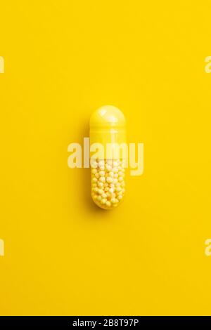 Closeup of one yellow pill on a white background with texture Stock Photo -  Alamy