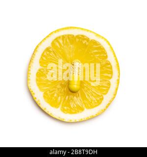 Vitamin capsules. Vitamin C pills and slice of lemon isolated on white background. Top view. Stock Photo