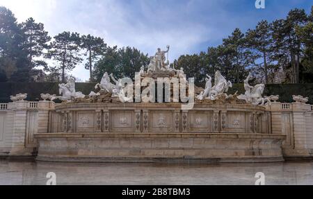 Vienna, Austria. Neptune Fountain (Neptunbrunnen) near Schonbrunn Palace in Schoenbruen Park. Statues of rearing horses and antique gods Stock Photo