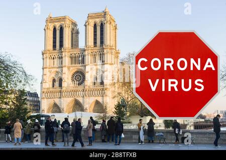 Concept image with large red Coronavirus warning sign in front of Notre Dame cathedral, travel restriction concept Stock Photo