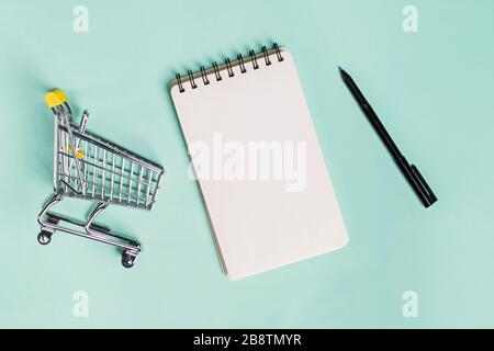 Small trolley, blank paper notepad and pen, top view. Stock Photo
