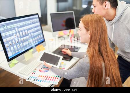 Woman as a web designer works with a web developer on a PC on a project Stock Photo