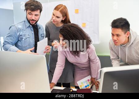 Web designers and developers as a team work together on a web design project Stock Photo