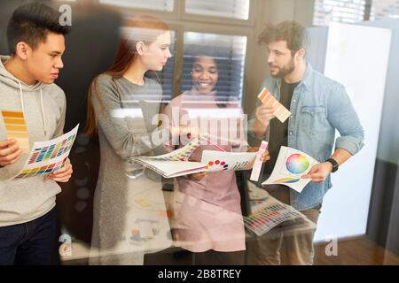 Web designers and graphic designers as a creative team discuss the color design of a website Stock Photo