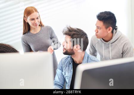 Graphic designers and web designers work as a team on the computer in the office Stock Photo