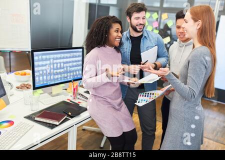 Web designers and web developers as a creative start-up team in a meeting Stock Photo