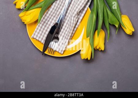 Festive table with yellow tulips. Stock Photo
