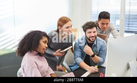 Creative start-up team of an internet agency is working on a web design project Stock Photo