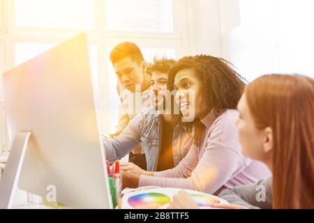 Web developers and web designers design websites together on the computer in the office Stock Photo