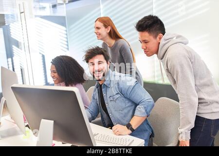 Creative young web designer team develops a project on the computer Stock Photo