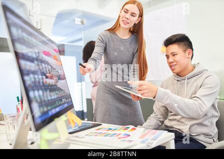 Programmers and women as web developers on the PC are working on a design project Stock Photo