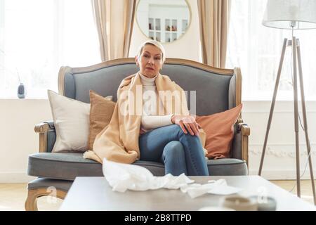 Serene senior lady relaxing on the sofa Stock Photo