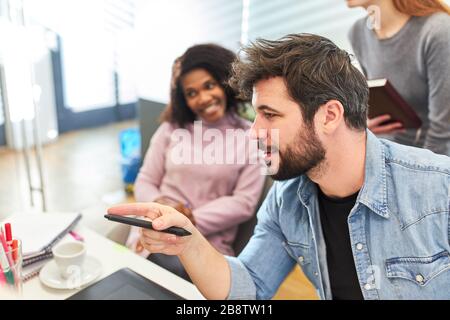 Young man as a web designer and web developer in a project meeting Stock Photo