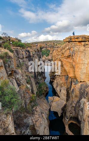 Man standing on top of cliffs at Bourke's luck potholes Mpumalanga South Africa on the scenic panorama route. Stock Photo