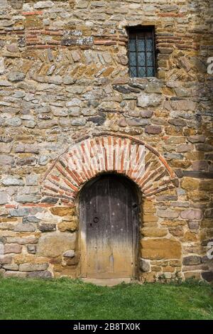 Doorway, incorporating a Roman brick archway, on the exterior of the Saxon church of All Saints, Brixworth, Northamptonshire, UK Stock Photo