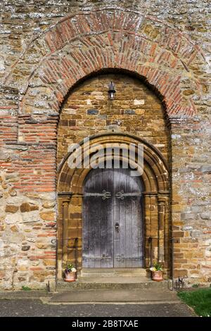 Doorway, incorporating a Roman brick archway, on the exterior of the Saxon church of All Saints, Brixworth, Northamptonshire, UK Stock Photo