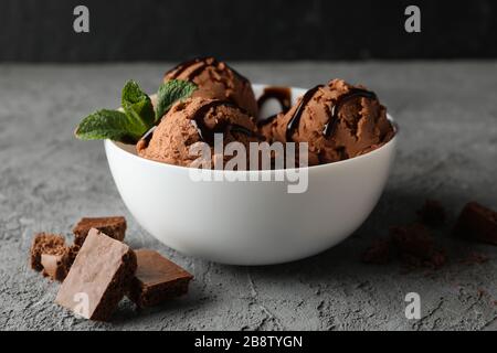 Bowl with ice cream on grey background, close up Stock Photo