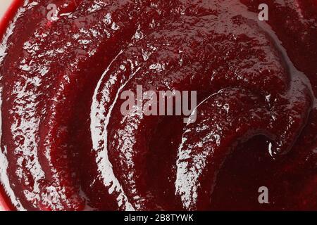 Beet cream soup on whole background, close up Stock Photo