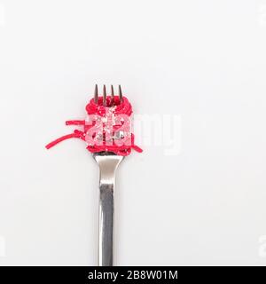 Spaghetti pasta with pink beetroot sause on a fork Stock Photo