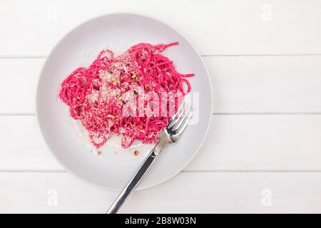 Spaghetti pasta with pink beetroot sause. Delicious lunch Stock Photo