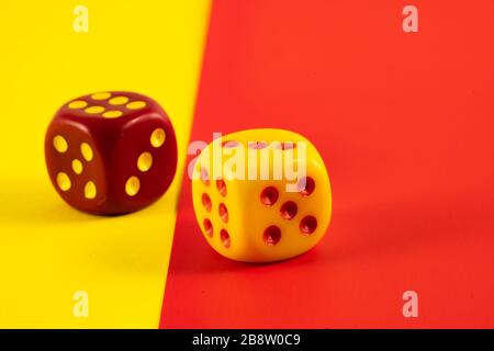 Lucky dice. Two red and yellow dice on red and yellow background, luck symbol Stock Photo