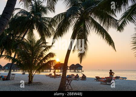 Sandy beach at sunset of tropical island in the Maldives Stock Photo
