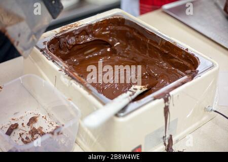 Making chocolate. . Chocolate factory. Liquid chocolate in a pan. Stock Photo