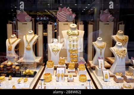 Golden jewellery displayed in a shop window on the Avenida do Infante Dom Henrique. Macau, China. Stock Photo