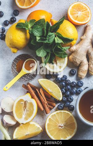 Ingredients for ginger tea. Ginger, lemon, mint and brown sugar on a ...