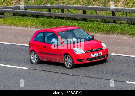 2003 red Ford Fiesta Finesse; UK vehicular traffic, transport, moving vehicles, vehicle, roads, motors, motoring  on the M6 motorway highway Stock Photo