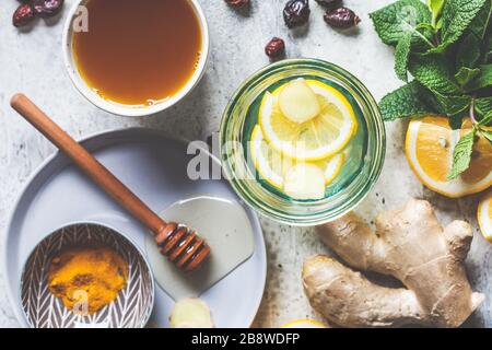 Warm drinks with turmeric, ginger, honey, mint and lemon. Beverage for raising immunity concept. Stock Photo