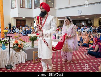 A Sikh bride and groom at their wedding ceremony in a temple in South Richmond Hill, Queens, New York City. Stock Photo