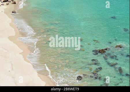 Close up view on white sanded beach with crystal clear blue water at Hahei, New Zealand Stock Photo