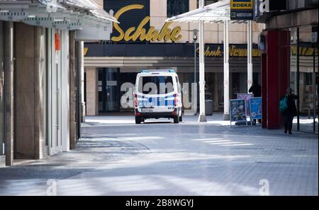 Hanover, Germany. 23rd Mar, 2020. A police car is patrolling the deserted downtown area. Credit: Julian Stratenschulte/dpa/Alamy Live News Stock Photo