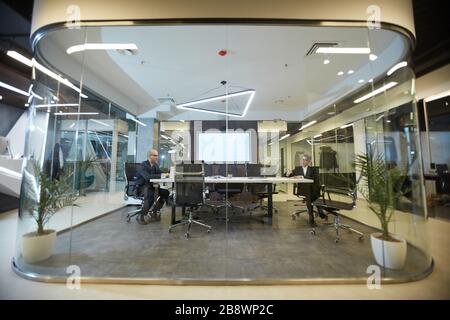 Wide angle view at futuristic office interior with glass conference room in center, copy space Stock Photo