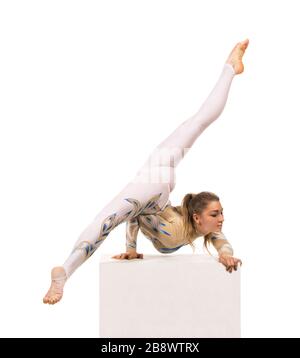 Acrobat doing gymnastics, a young circus artist in a white and blue ...