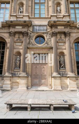 Antique inlaid wooden door with carved stone structure in an ancient palace in Paris. Stock Photo